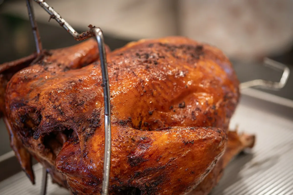 A golden roast turkey on a roasting rack
